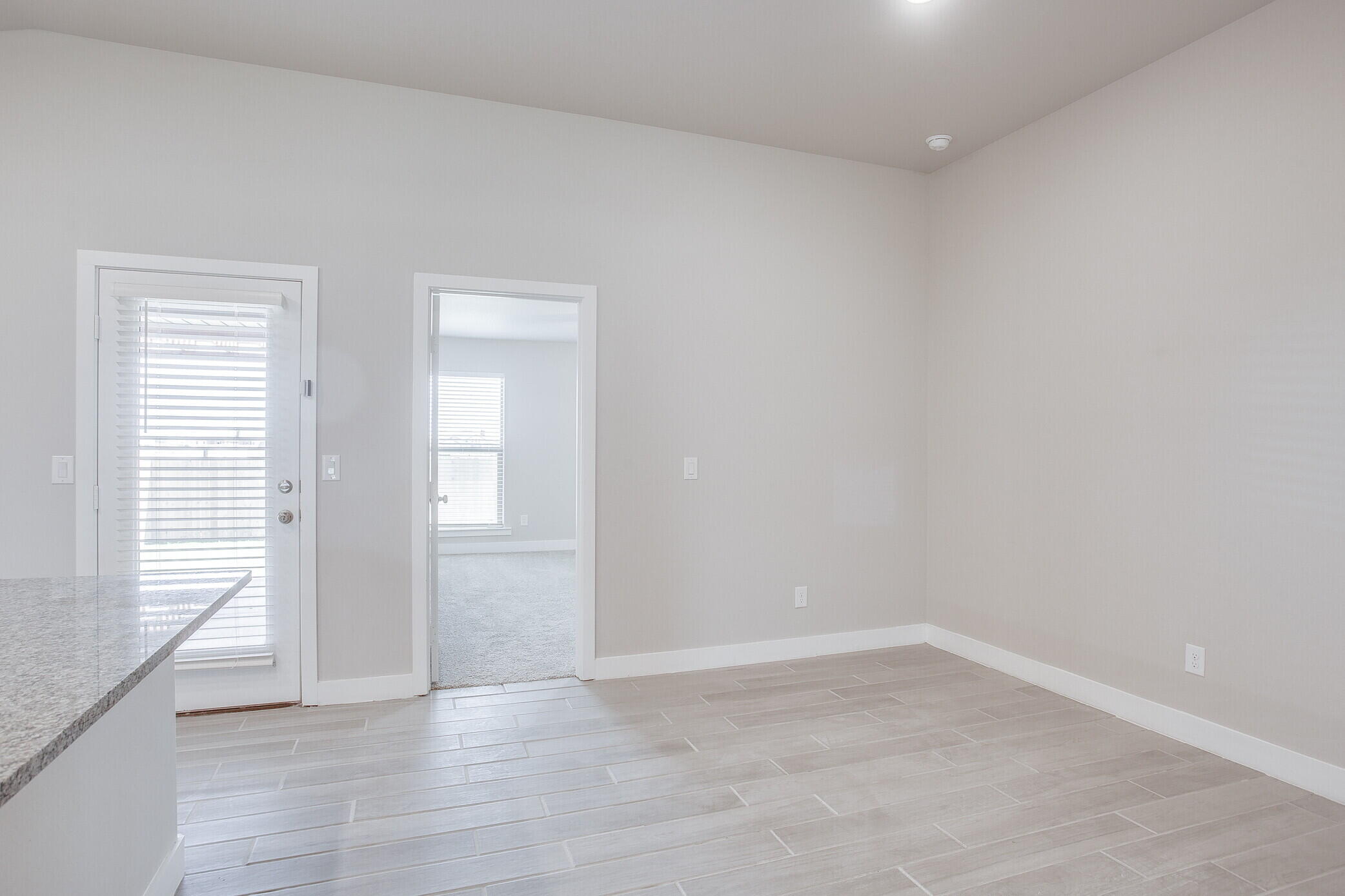 1905 140th Street Lubbock, TX 79423 - Photo 9 of 19 an empty room with wooden floor and windows