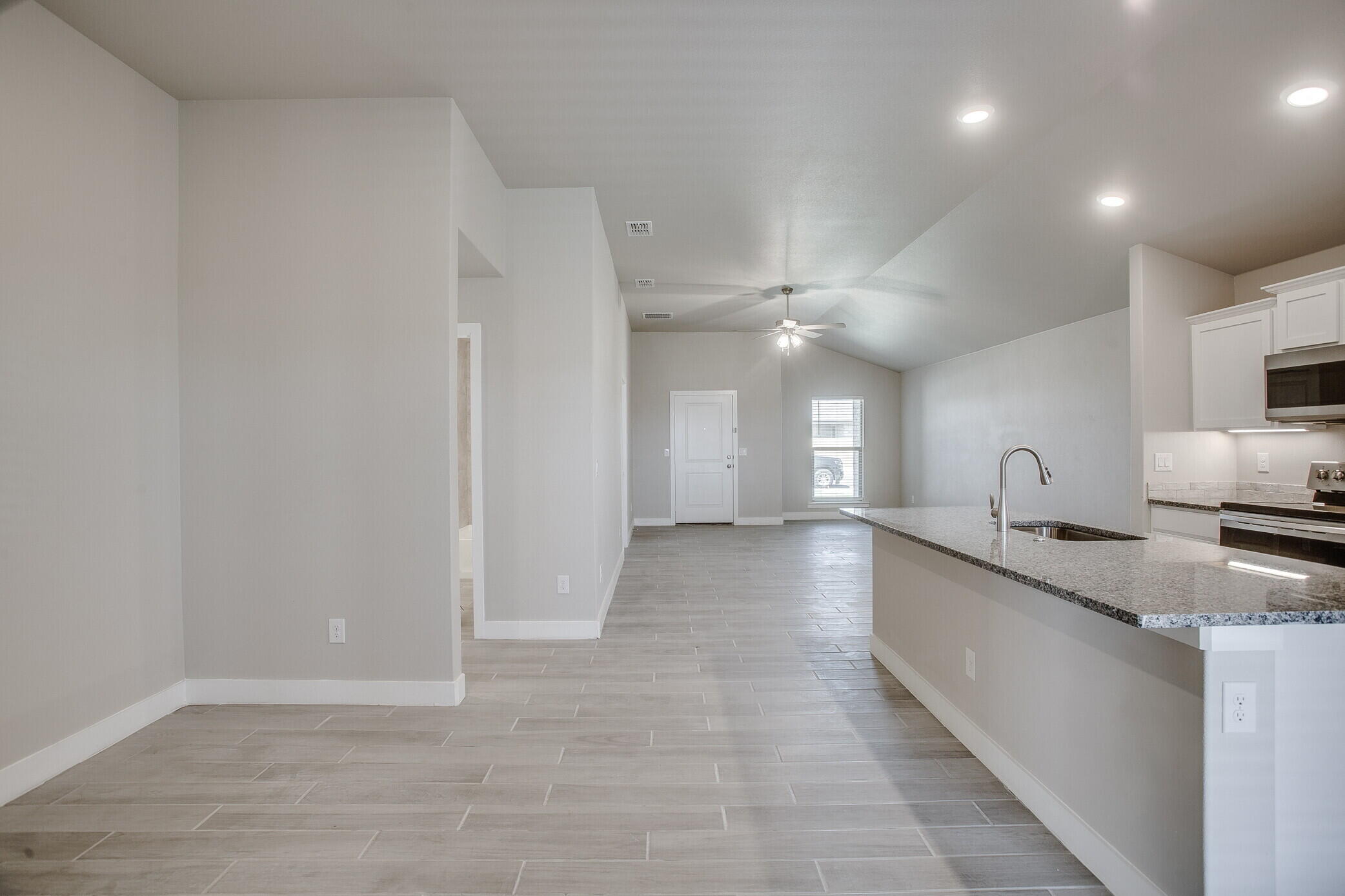 1905 140th Street Lubbock, TX 79423 - Photo 10 of 19 a view of a large kitchen with a sink and dishwasher stove