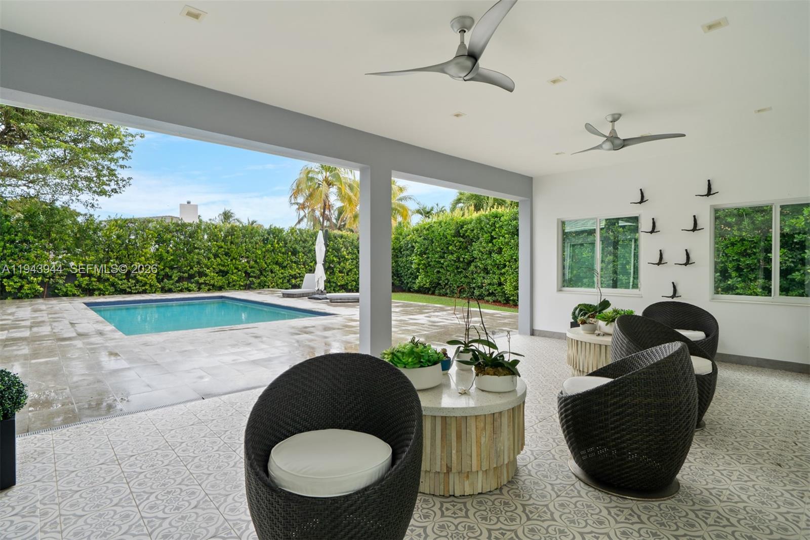 13333 Southwest 59th Court Pinecrest, FL 33156 - Photo 13 of 16 a living room with furniture and a large window