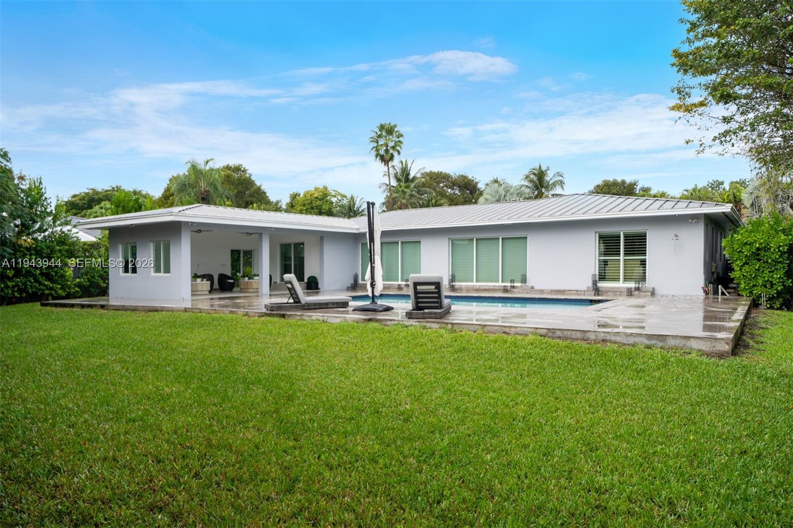 13333 Southwest 59th Court Pinecrest, FL 33156 - Photo 15 of 16 a front view of a house with yard patio and fire pit