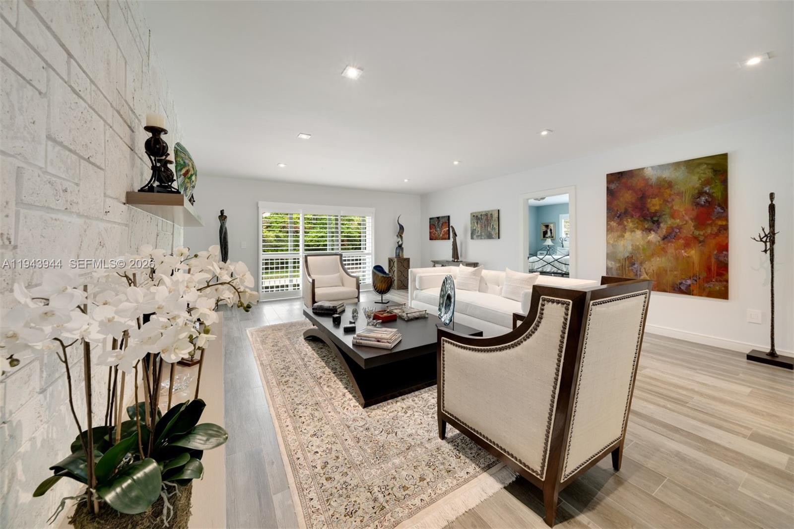 13333 Southwest 59th Court Pinecrest, FL 33156 - Photo 3 of 16 a living room with furniture and a flat screen tv