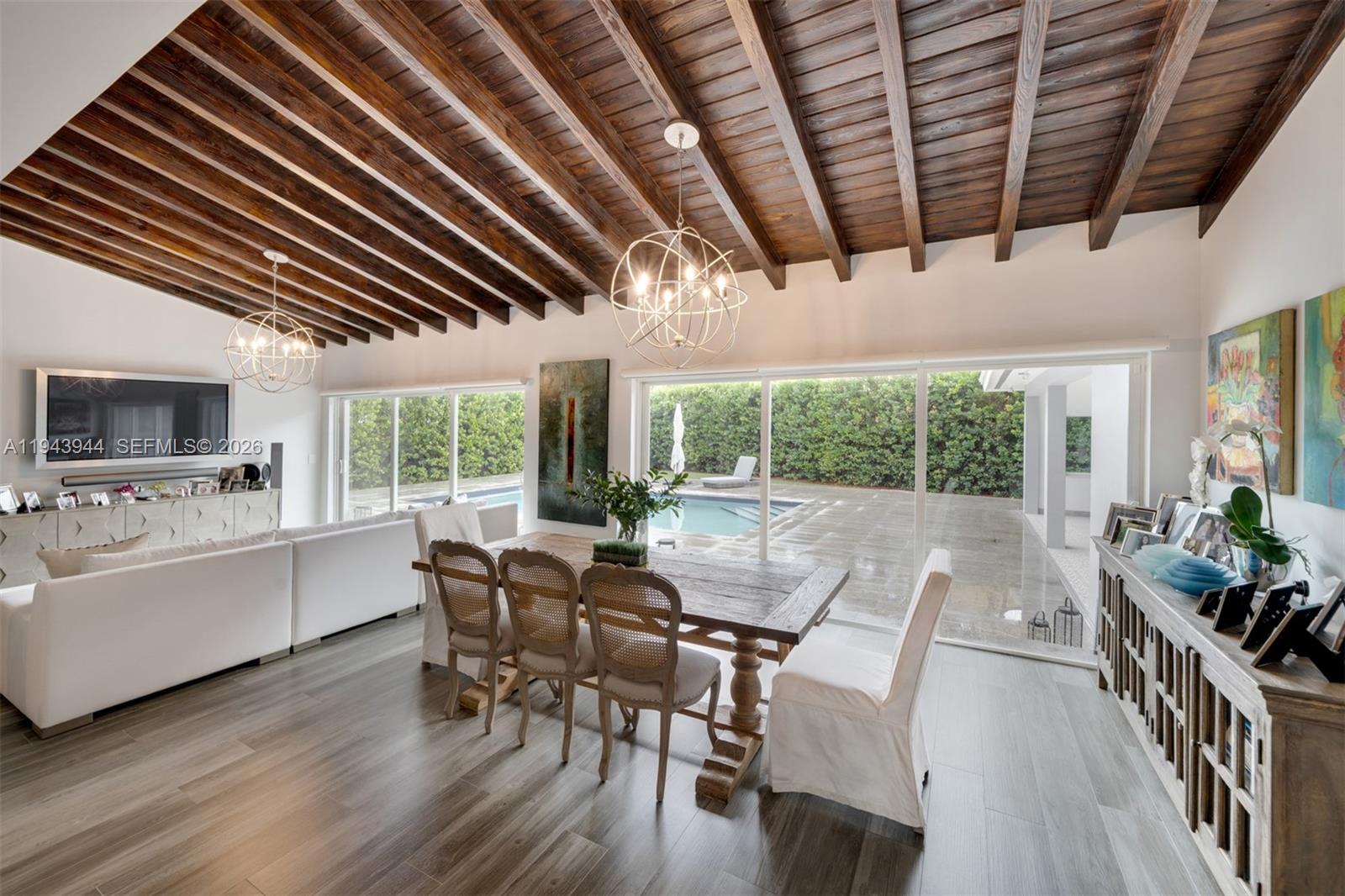 13333 Southwest 59th Court Pinecrest, FL 33156 - Photo 7 of 16 a view of a dining room with furniture window and wooden floor