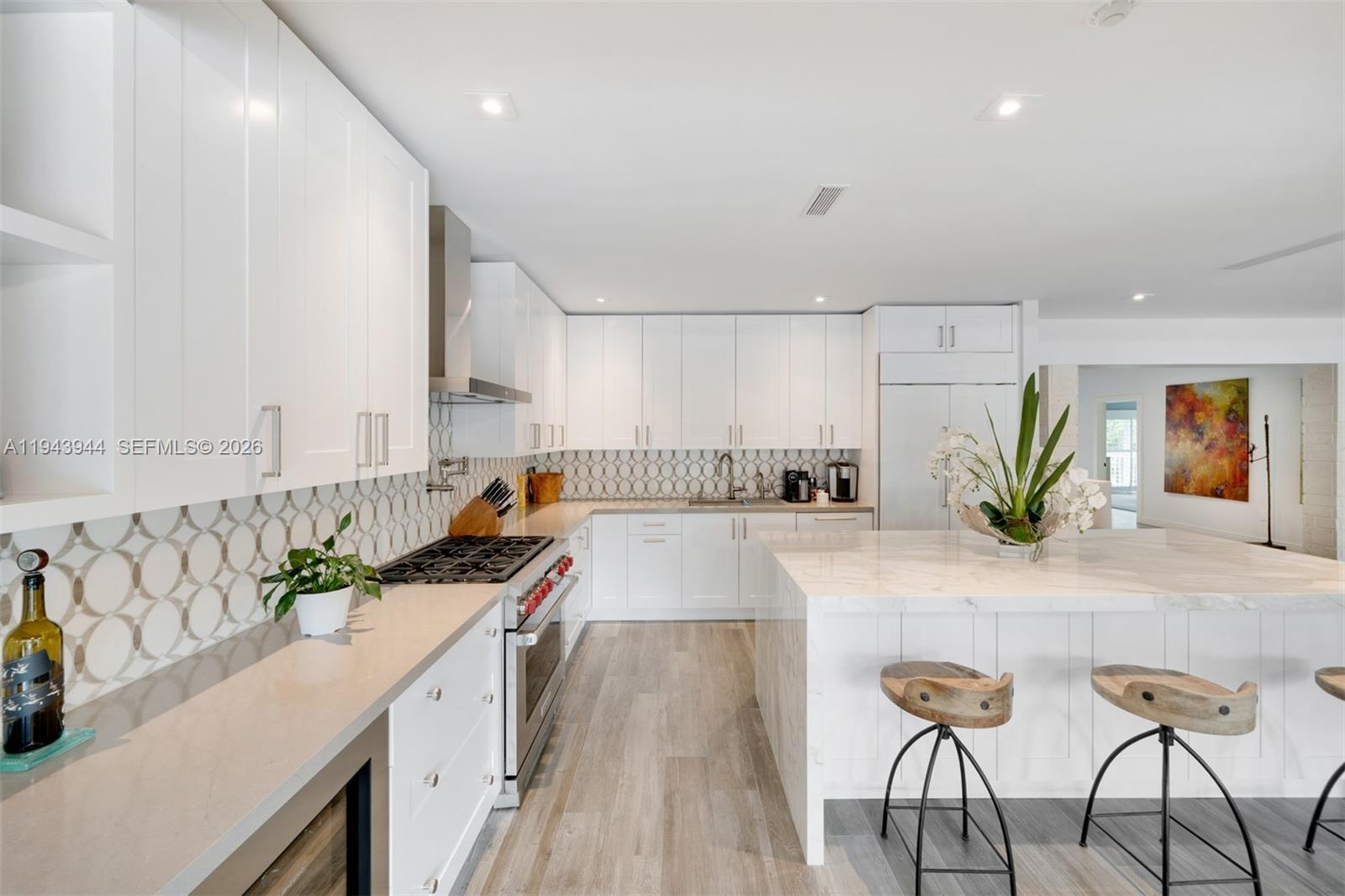 13333 Southwest 59th Court Pinecrest, FL 33156 - Photo 9 of 16 a view of a kitchen with kitchen island a counter top space a sink and cabinets