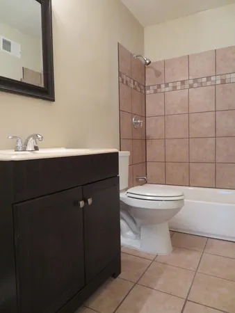 a bathroom with a toilet sink and shower