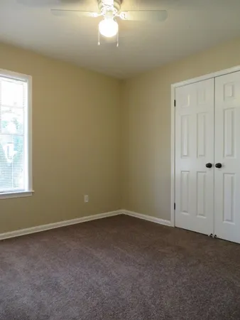 an empty room with a chandelier fan