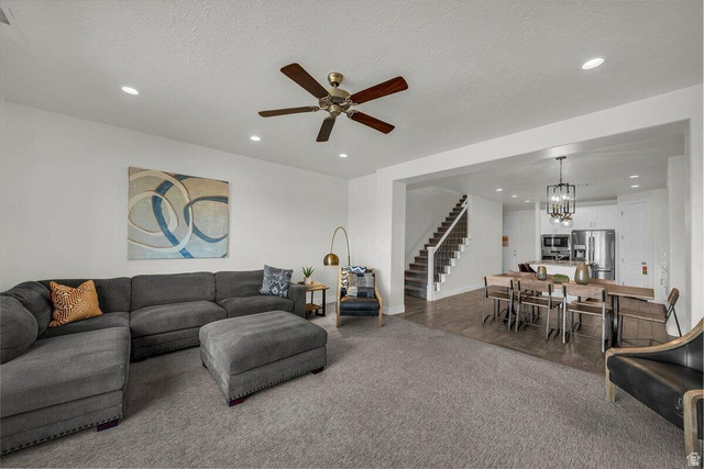 5010 Escapes Drive St. George, UT 84770 - Photo 7 of 46 Living area featuring ceiling fan, carpet flooring, suspended lighting, and a textured ceiling
