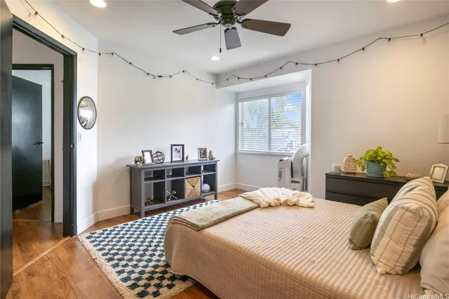 a bedroom with a bed dresser and a window