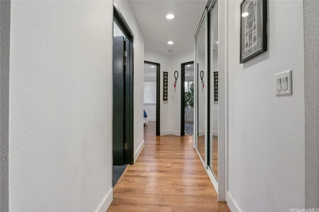 a view of a hallway with wooden floor