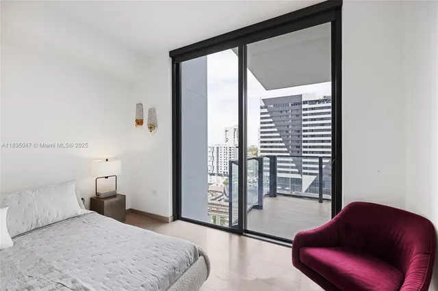 a bedroom with a large bed and a large window