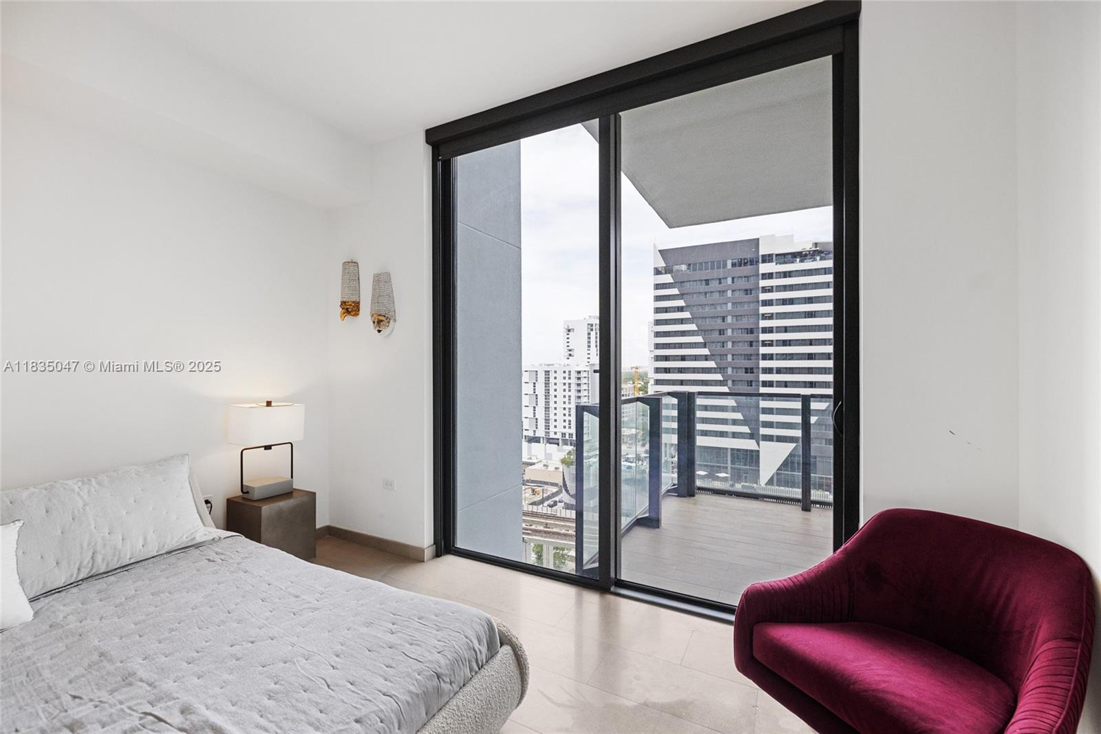 88 Southwest 7th Street, Unit 1010 Miami, FL 33130 - Photo 12 of 42 a bedroom with a large bed and a large window