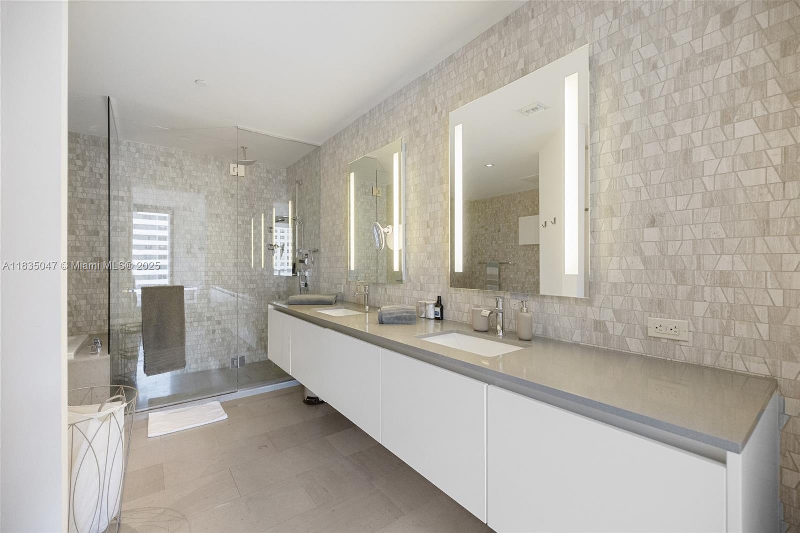 88 Southwest 7th Street, Unit 1010 Miami, FL 33130 - Photo 14 of 42 a large bathroom with a double vanity sink and a mirror