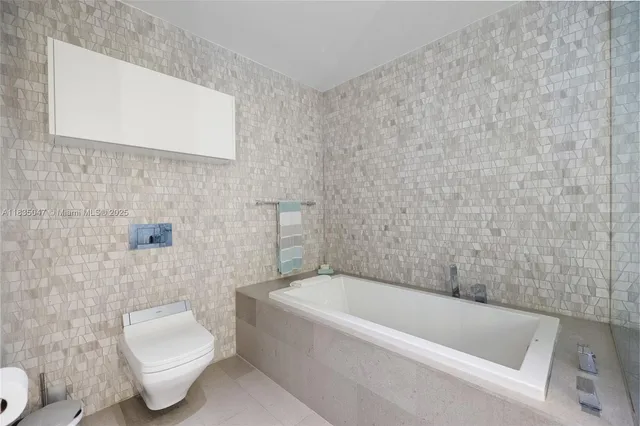 a bathroom with a toilet bathtub and sink