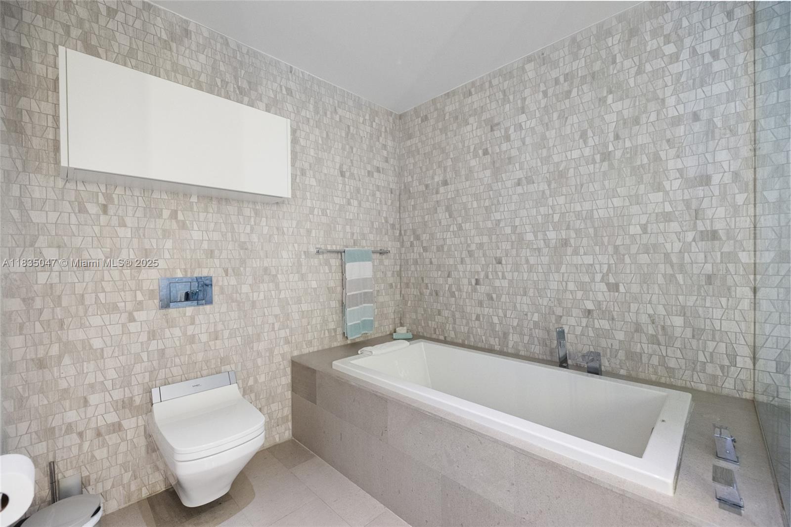 88 Southwest 7th Street, Unit 1010 Miami, FL 33130 - Photo 17 of 42 a bathroom with a toilet bathtub and sink