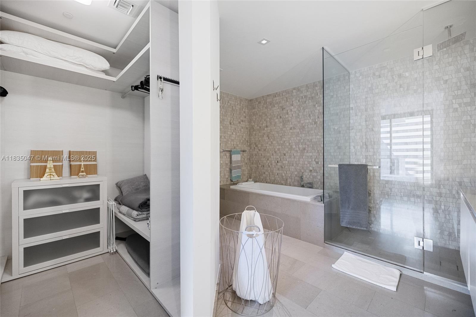 88 Southwest 7th Street, Unit 1010 Miami, FL 33130 - Photo 18 of 42 a bathroom with a bathtub and a shower