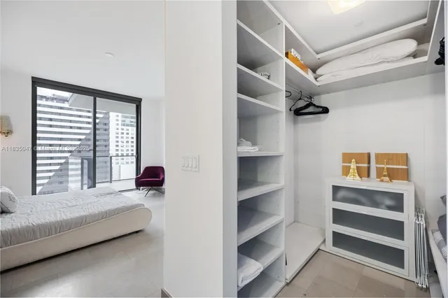 a bedroom with furniture and a window