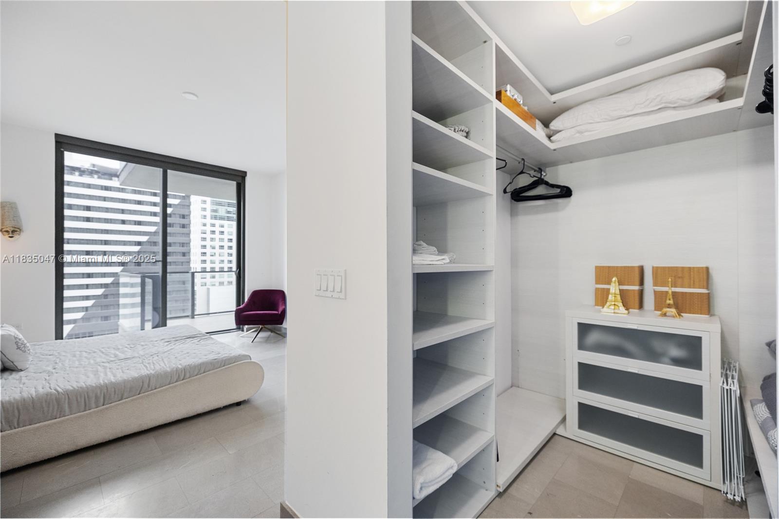 88 Southwest 7th Street, Unit 1010 Miami, FL 33130 - Photo 20 of 42 a bedroom with furniture and a window