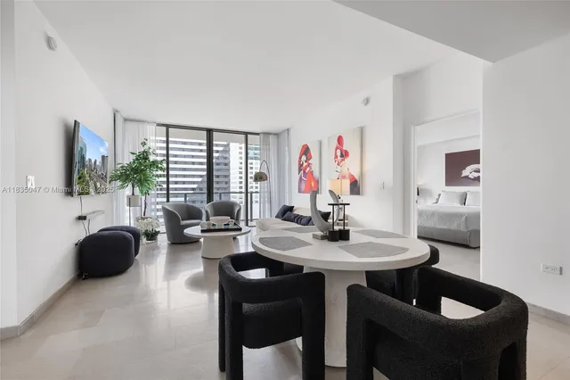 a view of a livingroom with furniture and a flat screen tv
