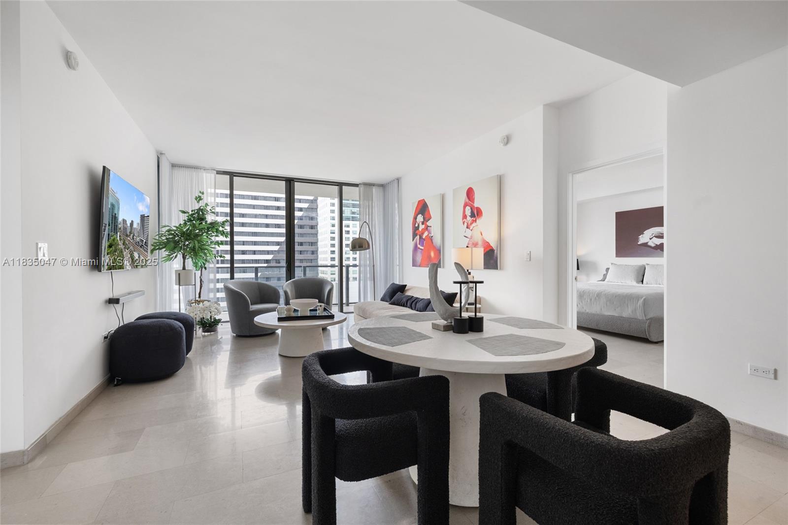88 Southwest 7th Street, Unit 1010 Miami, FL 33130 - Photo 2 of 42 a view of a livingroom with furniture and a flat screen tv