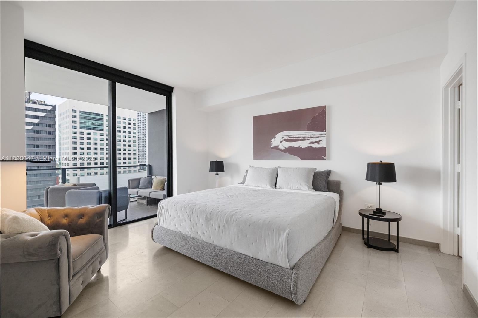 88 Southwest 7th Street, Unit 1010 Miami, FL 33130 - Photo 31 of 42 a bedroom with a bed couch and a large window