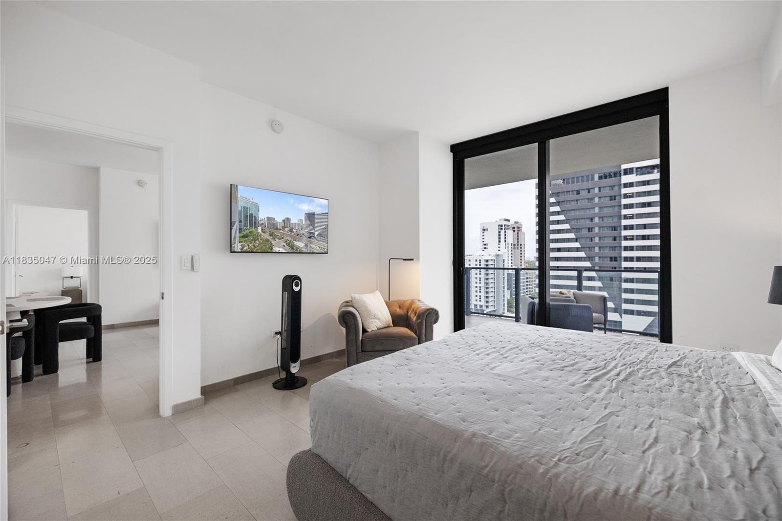 88 Southwest 7th Street, Unit 1010 Miami, FL 33130 - Photo 32 of 42 a bedroom with a large bed and a large window