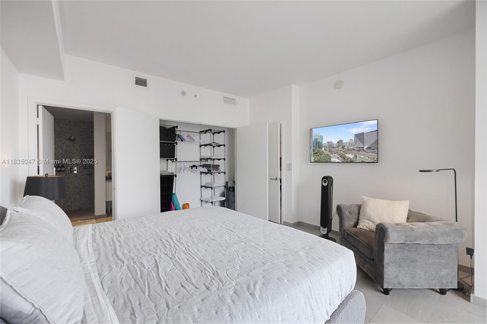 88 Southwest 7th Street, Unit 1010 Miami, FL 33130 - Photo 34 of 42 a bedroom with a bed and a dresser