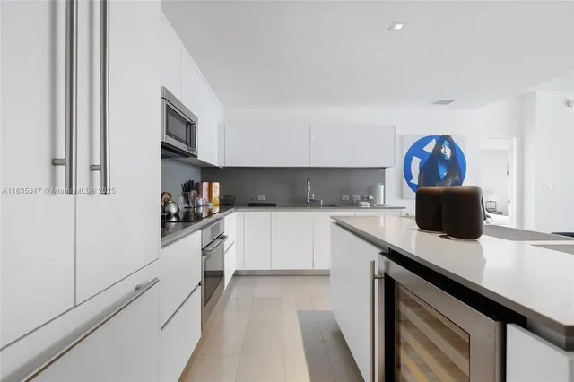 a kitchen with a sink cabinets and a stove top oven