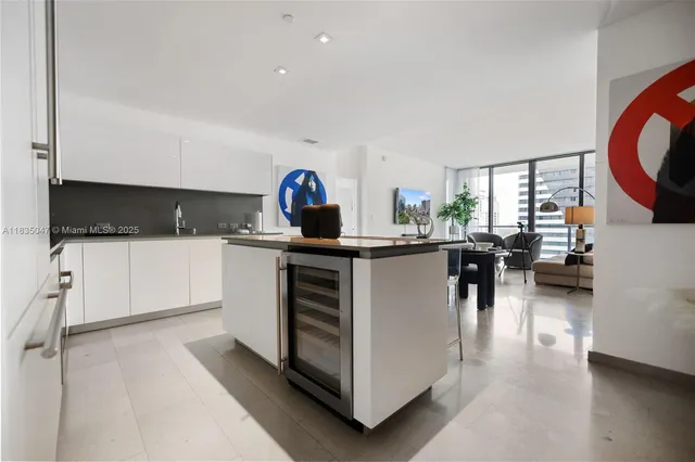 a kitchen with stainless steel appliances kitchen island granite countertop a sink and a stove top oven