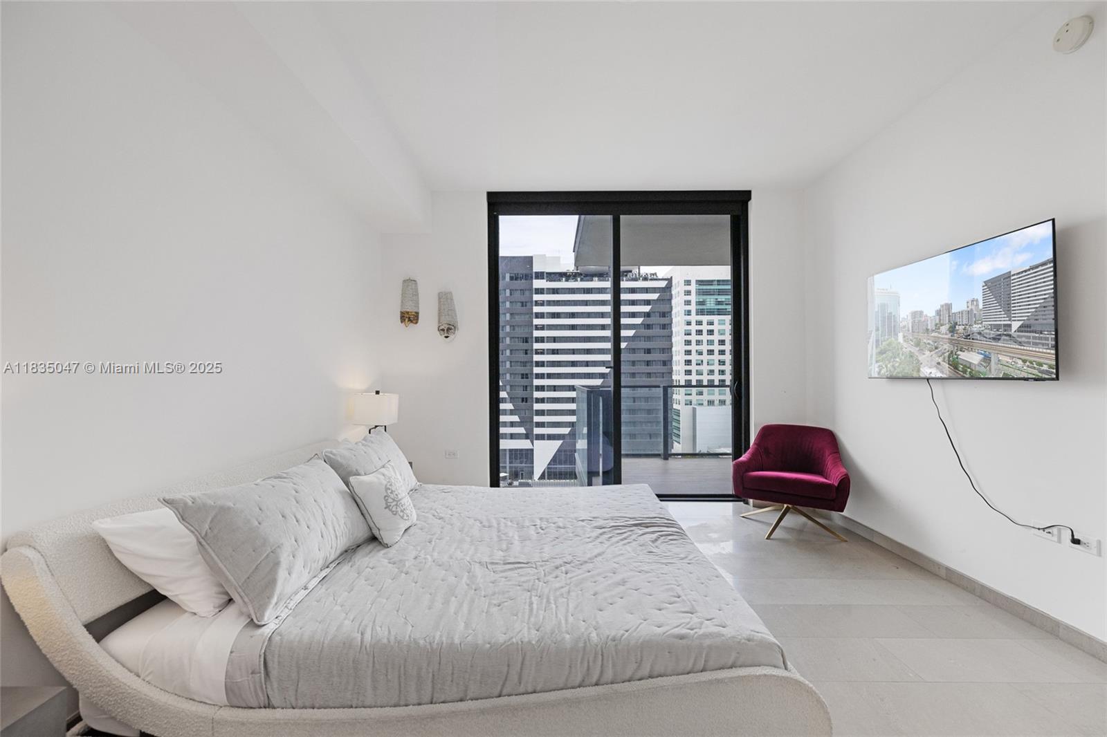 88 Southwest 7th Street, Unit 1010 Miami, FL 33130 - Photo 9 of 42 a bedroom with a bed and a couch