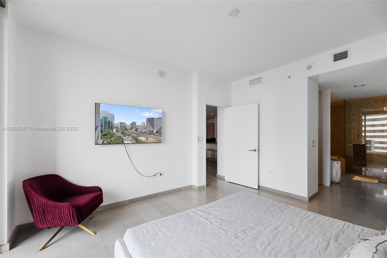 88 Southwest 7th Street, Unit 1010 Miami, FL 33130 - Photo 10 of 42 a spacious bedroom with a bed and a couch