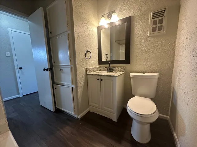a bathroom with a toilet a sink and a mirror