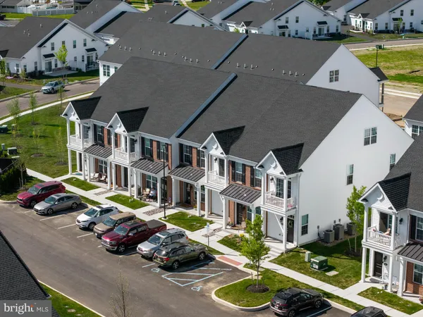 an aerial view of multiple houses with yard