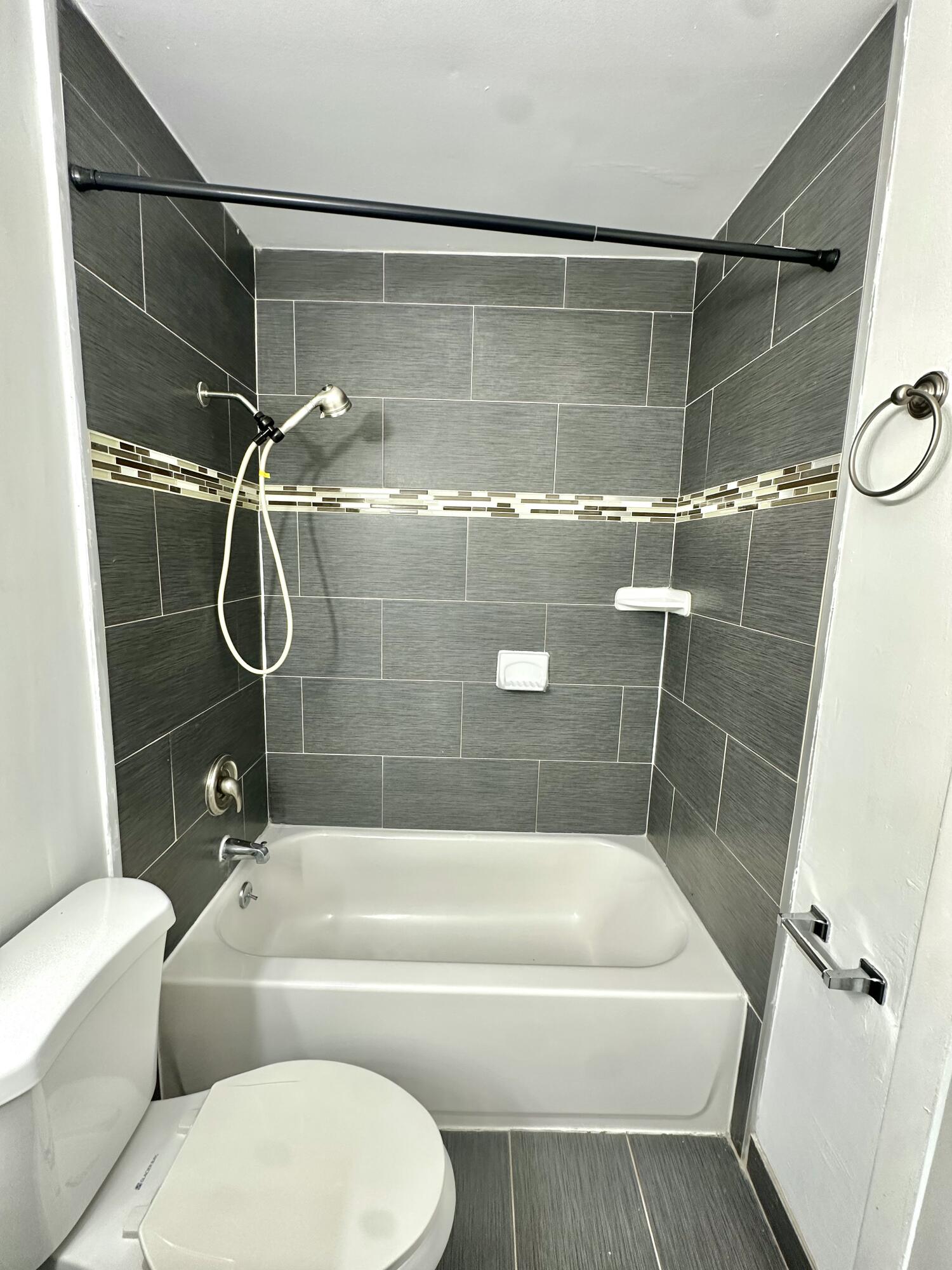 108 East Tiffany Drive, Unit 2 West Palm Beach, FL 33407 - Photo 13 of 14 a bathroom with a toilet and a bathtub