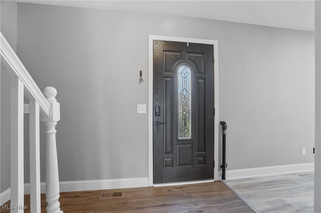9278 Bryant Road Windham, OH 44288 - Photo 36 of 47 Entryway with light wood-type flooring and stairway