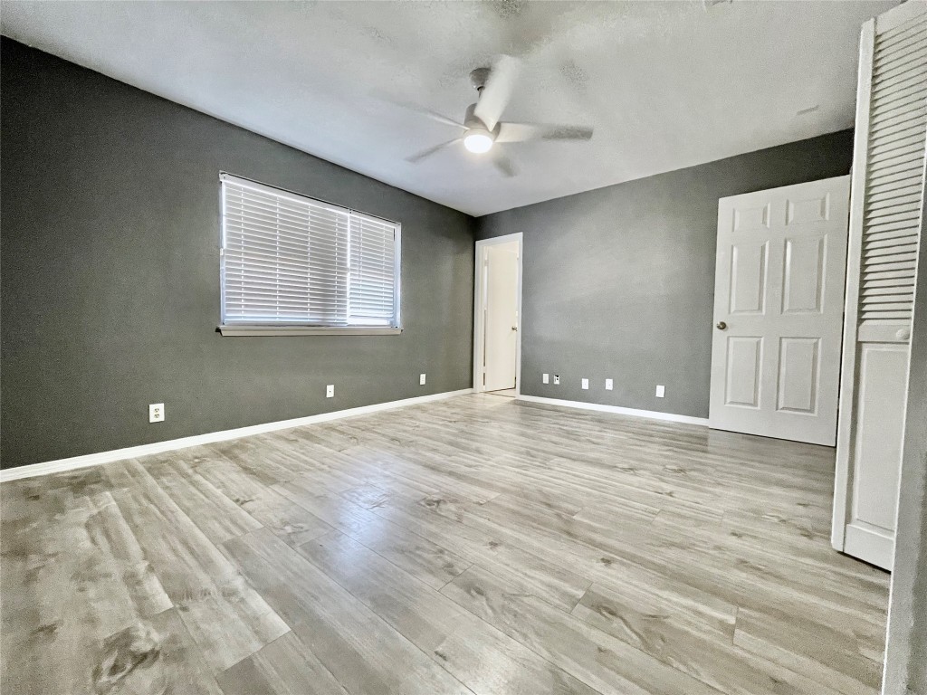 5929 Alsace Trail Austin, TX 78724 - Photo 14 of 18 an empty room with wooden floor and windows