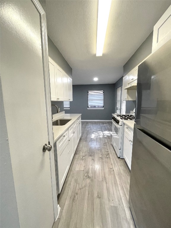 5929 Alsace Trail Austin, TX 78724 - Photo 4 of 18 a kitchen with granite countertop a sink and wooden floor