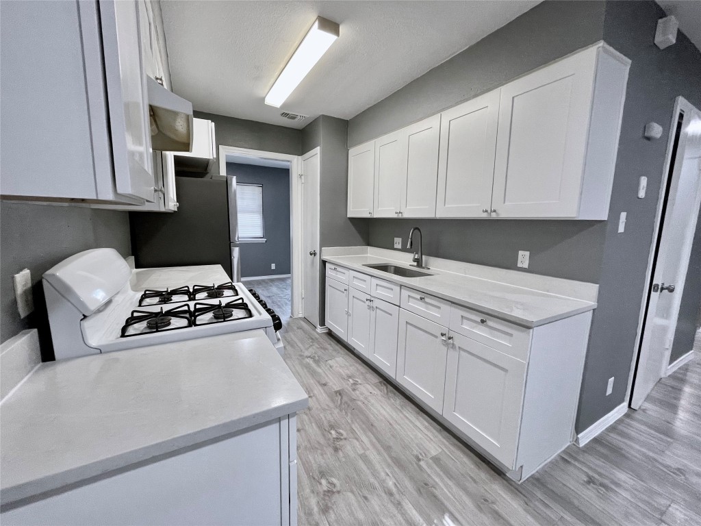 5929 Alsace Trail Austin, TX 78724 - Photo 6 of 18 a kitchen with white cabinets and appliances