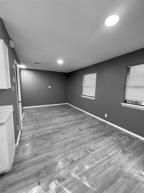 5929 Alsace Trail Austin, TX 78724 - Photo 7 of 18 an empty room with wooden floor and windows