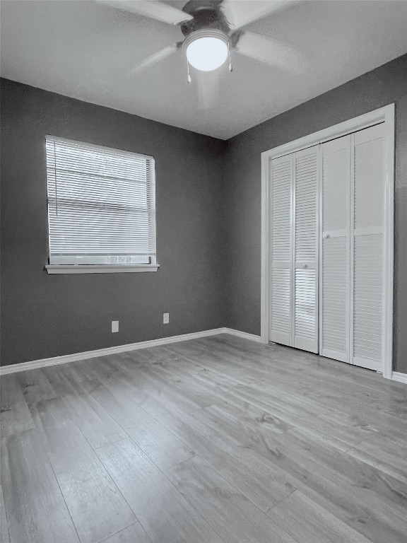 5929 Alsace Trail Austin, TX 78724 - Photo 9 of 18 an empty room with wooden floor and windows