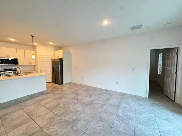 a view of kitchen with refrigerator cabinets and a counter top space