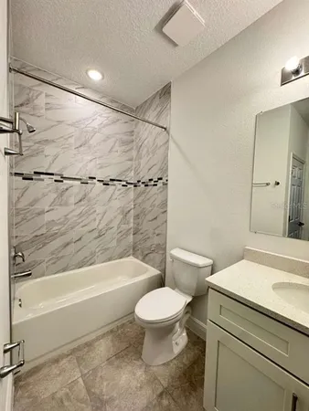 a bathroom with a toilet a sink and a bathtub