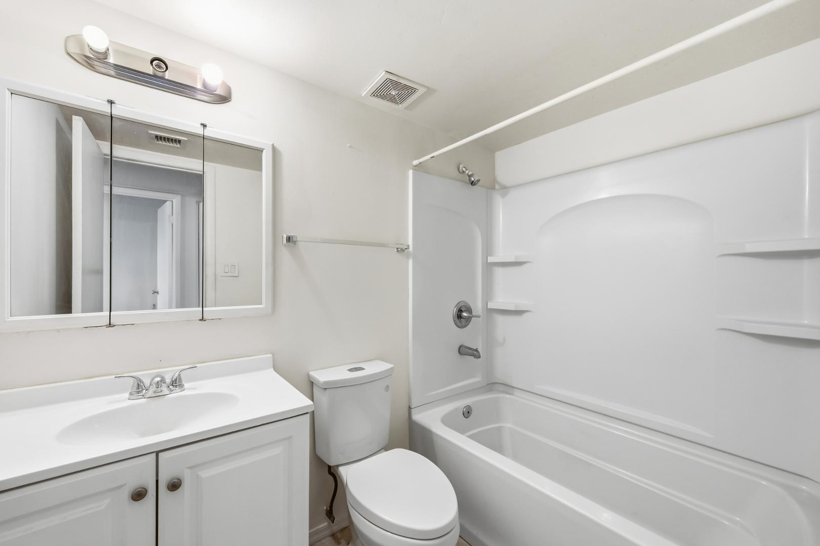 6705 West Devonshire Avenue Phoenix, AZ 85033 - Photo 2 of 11 a bathroom with a sink toilet vanity granite tub and shower