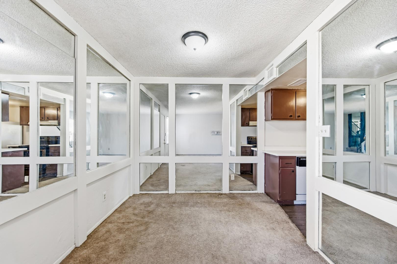 6705 West Devonshire Avenue Phoenix, AZ 85033 - Photo 6 of 11 a large white kitchen with granite countertop a large stove a sink and stainless steel appliances