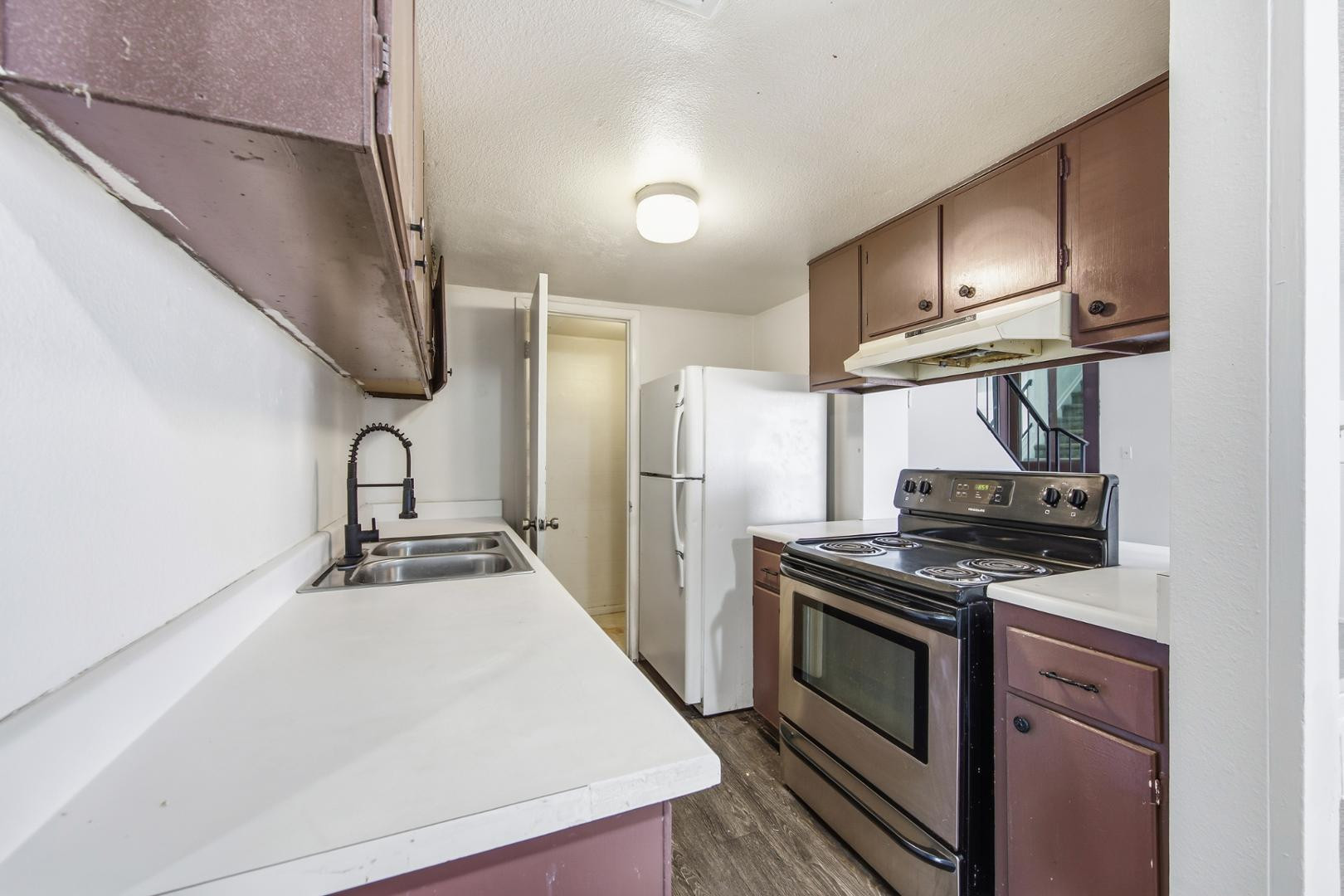 6705 West Devonshire Avenue Phoenix, AZ 85033 - Photo 9 of 11 a kitchen with stainless steel appliances a sink stove and refrigerator
