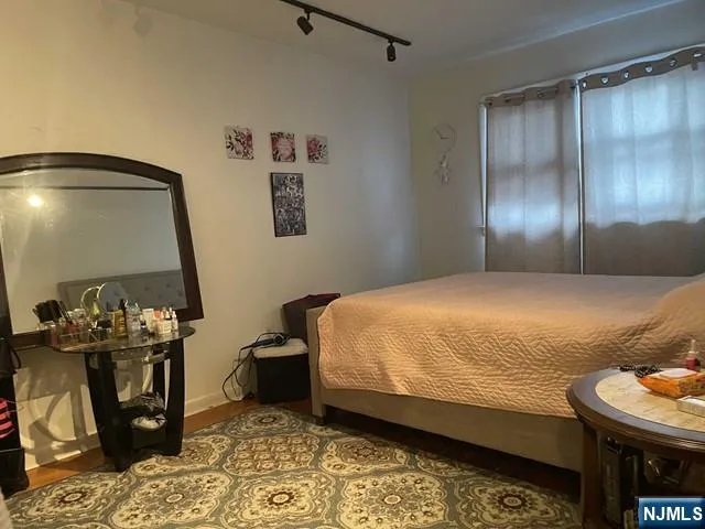 a bedroom with a bed and a mirror