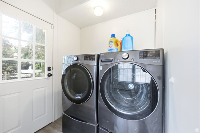 29 Grover Street Layton, UT 84041 - Photo 21 of 29 Dedicated laundry area featuring a white paneled door with glass inserts, wood-finish flooring, and a flush-mount ceiling light fixture