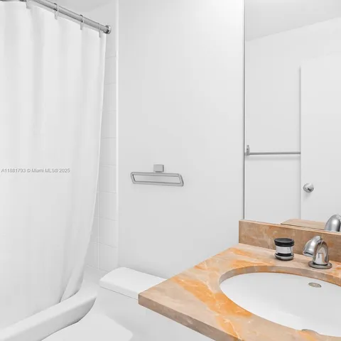 a kitchen with white cabinets stainless steel appliances and sink