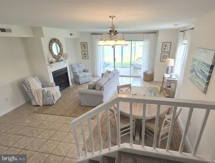 a living room with furniture and a chandelier