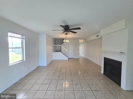 a view of an empty room and a fireplace