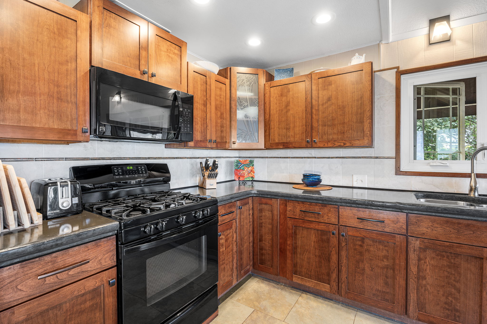 78-6960-a Walua Road Kailua-Kona, HI 96740 - Photo 14 of 29 a kitchen with stainless steel appliances a stove sink and microwave