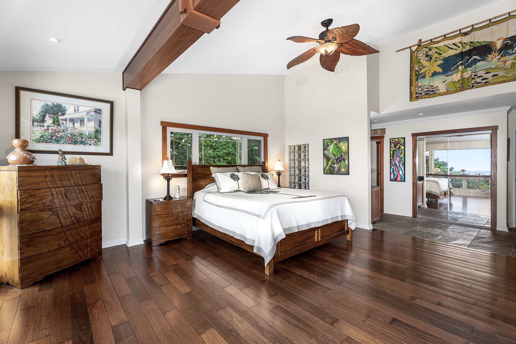 78-6960-a Walua Road Kailua-Kona, HI 96740 - Photo 17 of 29 a spacious bedroom with a bed a dresser and wooden floor